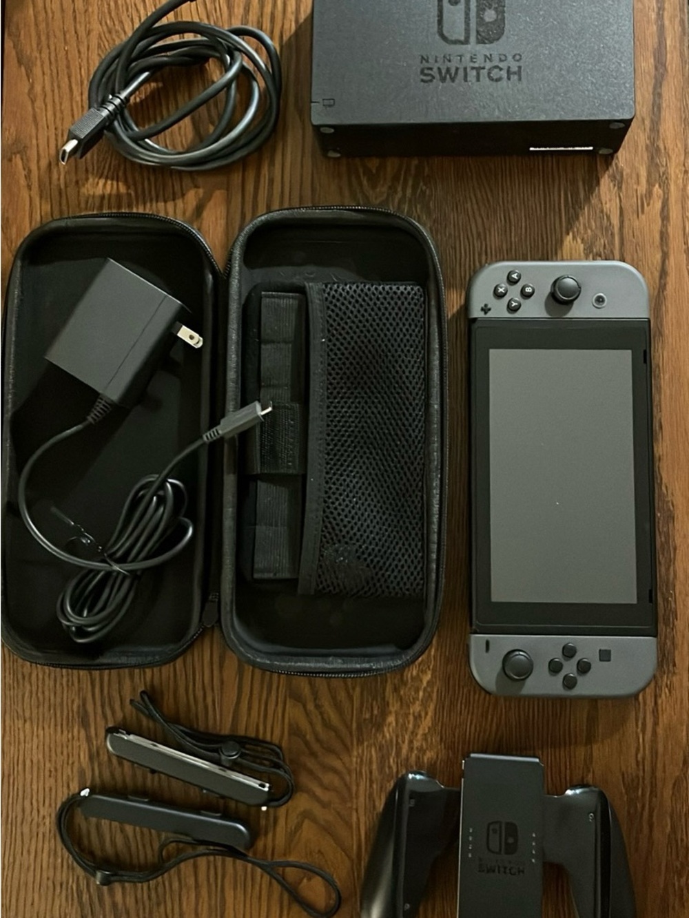 Nintendo Switch with Dark Gray Joy‑Con and Black Accessories
